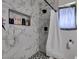 Bathroom showcasing a marble tiled shower with a built-in niche and modern fixtures at 513 Berry Cir, Las Vegas, NV 89107