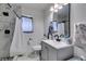 Well-lit bathroom featuring a marble tile shower and modern vanity at 513 Berry Cir, Las Vegas, NV 89107