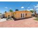Rear exterior view of property showcasing stucco, brick paved backyard, and back entrance at 513 Berry Cir, Las Vegas, NV 89107
