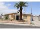 Charming single-story home with a palm tree in front and a brick-lined walkway to the front door at 513 Berry Cir, Las Vegas, NV 89107