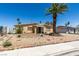 Charming single-story home featuring desert landscaping, a front yard palm tree, and a covered front porch at 513 Berry Cir, Las Vegas, NV 89107