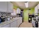 View of the kitchen with white cabinets, stainless steel appliances and granite countertops at 513 Berry Cir, Las Vegas, NV 89107