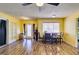 Open-concept living space with laminate floors, dining area, and sliding glass door at 513 Berry Cir, Las Vegas, NV 89107