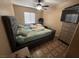 Bedroom featuring a tufted headboard and a dresser with a TV at 5281 Starter Ave, Las Vegas, NV 89156
