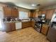 Well-lit kitchen features wooden cabinets, modern appliances, and laminate wood flooring at 5281 Starter Ave, Las Vegas, NV 89156