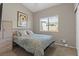 Cozy bedroom with a large window, soft carpeting, and neutral wall colors at 5421 Tourmaline St, Las Vegas, NV 89130