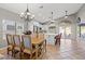 Formal dining room featuring chandelier, tile floors, view to the kitchen, and natural light at 5421 Tourmaline St, Las Vegas, NV 89130