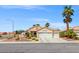 Charming single-story home with a three-car garage, desert landscaping, and a beautiful palm tree at 5421 Tourmaline St, Las Vegas, NV 89130