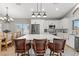 Open kitchen features stainless steel appliances, an expansive center island with seating, and adjoins the dining area at 5421 Tourmaline St, Las Vegas, NV 89130