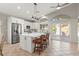 Bright and airy kitchen features an island with seating, stainless appliances, and stylish pendant lighting at 5421 Tourmaline St, Las Vegas, NV 89130