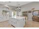 Modern kitchen with a large center island, white cabinets, and views of the outdoor patio at 5421 Tourmaline St, Las Vegas, NV 89130
