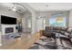 Bright living room with hardwood floors, a fireplace, high ceilings, and natural light at 5421 Tourmaline St, Las Vegas, NV 89130