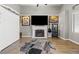 Living room featuring a fireplace with decorative tile, wood floors, neutral paint, and vaulted ceiling at 5421 Tourmaline St, Las Vegas, NV 89130