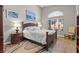 Main bedroom features wood flooring, an arched window, and artwork at 5421 Tourmaline St, Las Vegas, NV 89130