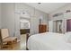 Comfortable main bedroom with an ensuite bathroom, a wooden chair, and hardwood floors at 5421 Tourmaline St, Las Vegas, NV 89130