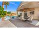 Inviting covered patio with outdoor seating and dining areas overlooking a sparkling pool at 5421 Tourmaline St, Las Vegas, NV 89130