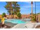Backyard pool with spa, mature landscaping, tanning deck, and lounge chairs at 5421 Tourmaline St, Las Vegas, NV 89130