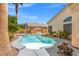 Backyard pool surrounded by mature landscaping, trees, and a lounging area at 5421 Tourmaline St, Las Vegas, NV 89130