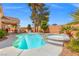 Inviting backyard pool and spa with mature landscaping, lounge seating, and patio area at 5421 Tourmaline St, Las Vegas, NV 89130