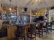 Stylish bar area featuring stone accents, well-stocked shelves, and comfortable bar stools at 5445 Pendini Point Ct, Las Vegas, NV 89141