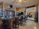 Inviting bar area with granite countertop, comfortable seating, and wood cabinetry at 5445 Pendini Point Ct, Las Vegas, NV 89141