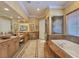 Elegant bathroom features dual vanities, a soaking tub, and a glass-enclosed shower at 5445 Pendini Point Ct, Las Vegas, NV 89141