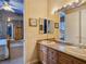 Well-lit bathroom with a double sink vanity and access to an adjoining bedroom at 5445 Pendini Point Ct, Las Vegas, NV 89141