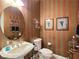 Charming powder room with striped wallpaper, a pedestal sink, and decorative accents at 5445 Pendini Point Ct, Las Vegas, NV 89141
