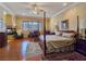 Large bedroom with hardwood floors, a fireplace, and a comfortable sitting area at 5445 Pendini Point Ct, Las Vegas, NV 89141