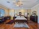 Spacious bedroom with hardwood floors, ceiling fan, and elegant four-poster bed at 5445 Pendini Point Ct, Las Vegas, NV 89141