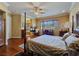 Bright bedroom with hardwood floors, fireplace, and a comfortable sitting area at 5445 Pendini Point Ct, Las Vegas, NV 89141