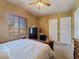 Comfortable bedroom offers window views and warm lighting that adds to the charming decor at 5445 Pendini Point Ct, Las Vegas, NV 89141