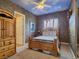 Cozy bedroom features neutral tones, decorative wall art, and a unique ceiling fan at 5445 Pendini Point Ct, Las Vegas, NV 89141