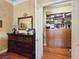 A well-organized closet with drawers, shelves and a dark wood dresser at 5445 Pendini Point Ct, Las Vegas, NV 89141