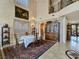 Formal dining room with a large window, chandelier, and elegant furnishings at 5445 Pendini Point Ct, Las Vegas, NV 89141