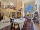 Elegant dining room with a long table, ornate chairs, and a view into the formal living room at 5445 Pendini Point Ct, Las Vegas, NV 89141