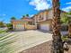 Exterior view showcasing a well-manicured lawn, mature palm trees, and three-car garage at 5445 Pendini Point Ct, Las Vegas, NV 89141