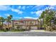 Elegant two-story home featuring a tiled roof, desert landscaping, and an attached two car garage at 5445 Pendini Point Ct, Las Vegas, NV 89141