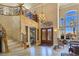 Grand foyer with soaring ceilings, a sweeping staircase, and a view into the living area at 5445 Pendini Point Ct, Las Vegas, NV 89141