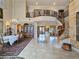 Spacious foyer with a winding staircase, tile floors, and views into multiple living spaces at 5445 Pendini Point Ct, Las Vegas, NV 89141