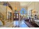 Grand foyer with soaring ceilings, a sweeping staircase, and a view into the living area at 5445 Pendini Point Ct, Las Vegas, NV 89141