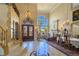 Grand foyer with soaring ceilings, a sweeping staircase, and a view into the living area at 5445 Pendini Point Ct, Las Vegas, NV 89141