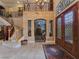 Elegant foyer with staircase, stone accents, and custom wrought iron details at 5445 Pendini Point Ct, Las Vegas, NV 89141