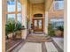 Elegant entryway showcasing stone accents, a detailed wooden double door, and manicured landscaping at 5445 Pendini Point Ct, Las Vegas, NV 89141