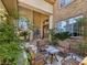 Welcoming front entrance with outdoor seating and lush landscaping enhancing curb appeal at 5445 Pendini Point Ct, Las Vegas, NV 89141