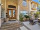 Elegant home entrance featuring a stone facade, double doors, and outdoor seating area at 5445 Pendini Point Ct, Las Vegas, NV 89141