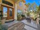 Elegant home entrance featuring a stone facade, double doors, and outdoor seating area at 5445 Pendini Point Ct, Las Vegas, NV 89141