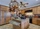 Kitchen island with granite top, custom cabinets, and stainless steel appliances at 5445 Pendini Point Ct, Las Vegas, NV 89141