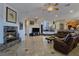 Spacious and open living area with a cozy fireplace and adjacent kitchen at 5445 Pendini Point Ct, Las Vegas, NV 89141