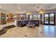 Open living area with tile floors, leather seating, and doors leading to the pool area at 5445 Pendini Point Ct, Las Vegas, NV 89141